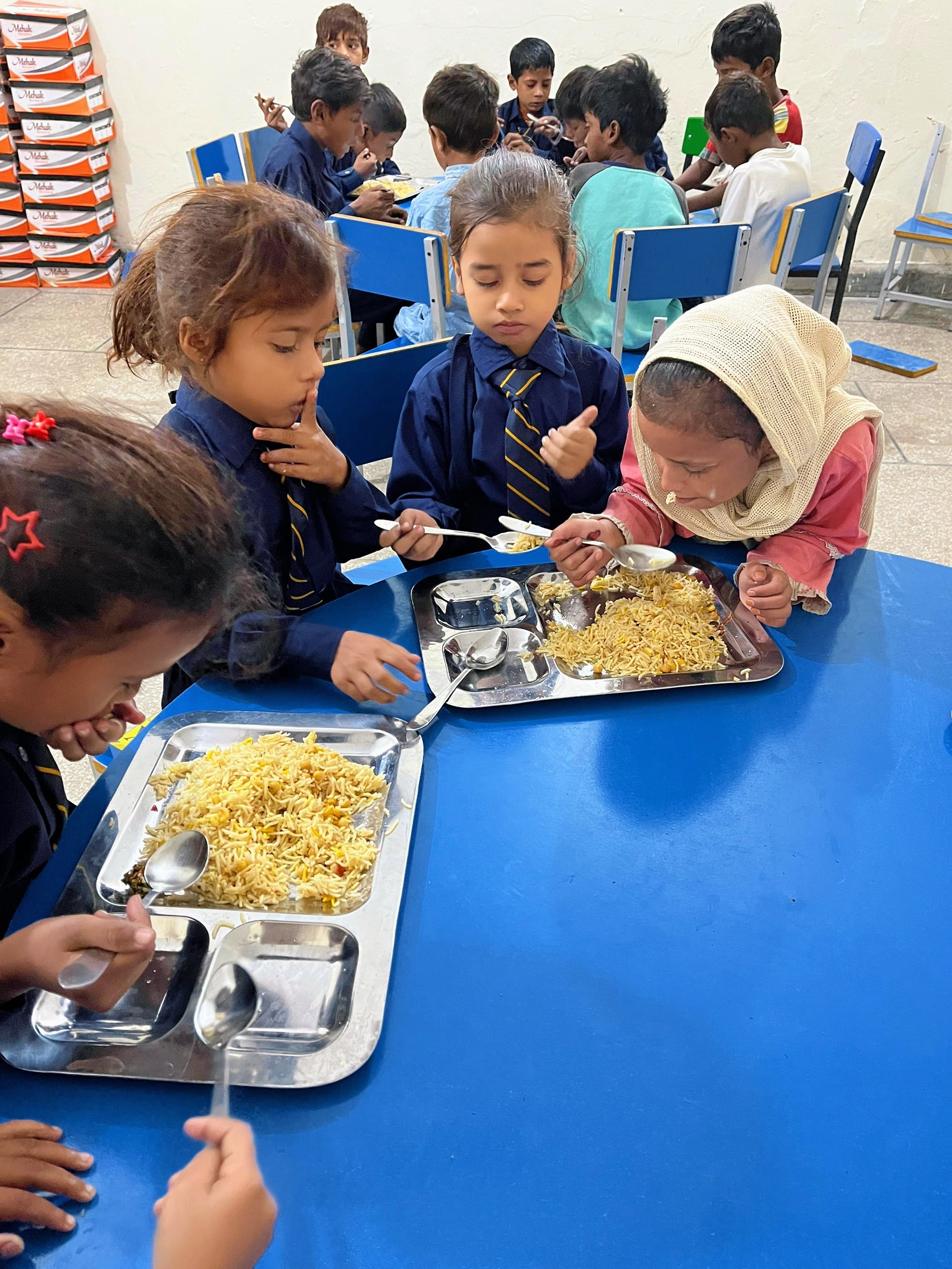 Children receiving nutritious meals at Nayi Uraan Foundation