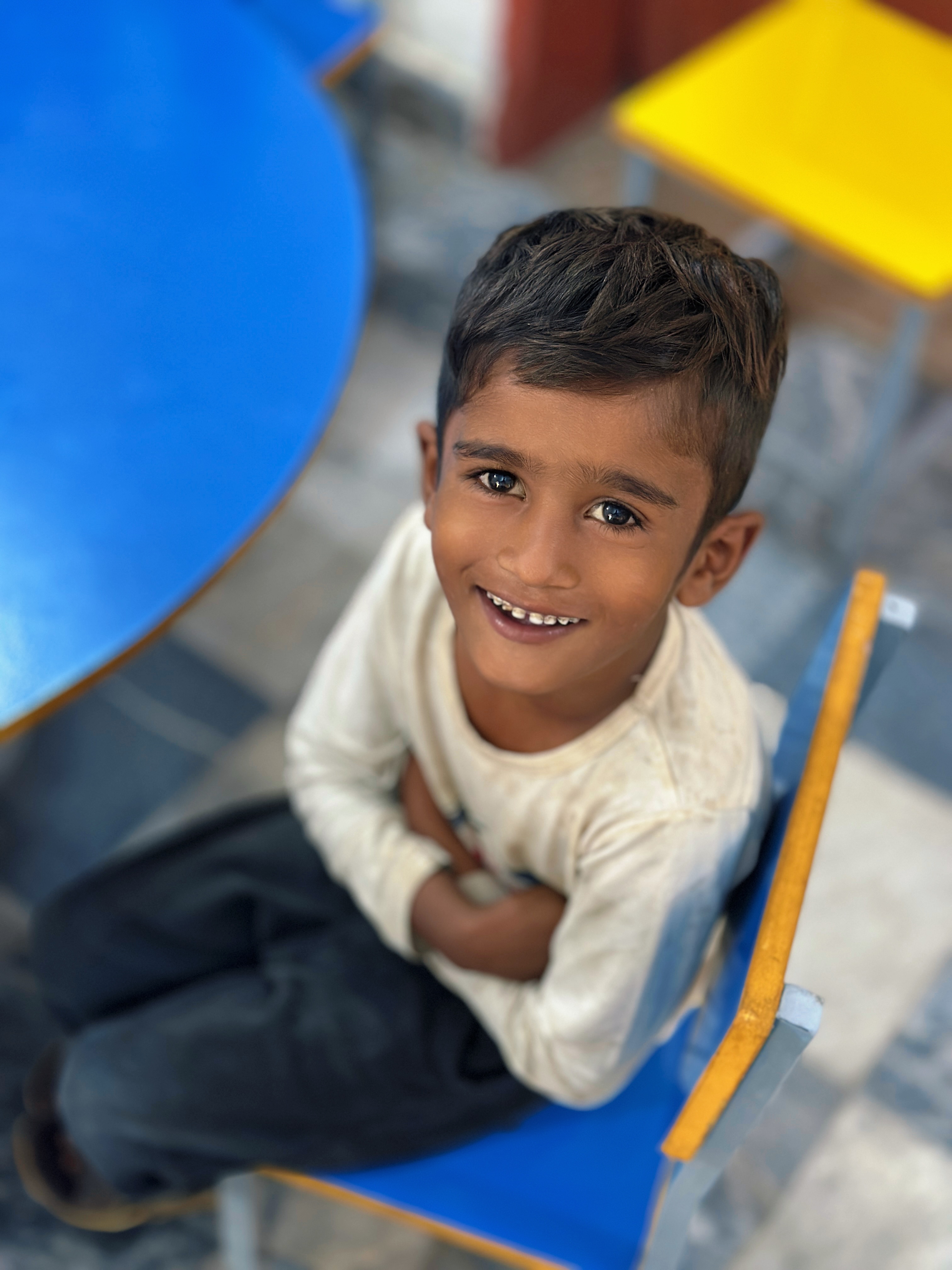 Child smiling and looking at you for help